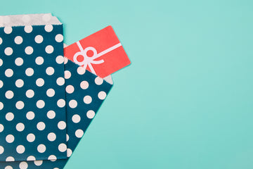 Gift cards wrapped with holiday ribbons and seasonal packaging
