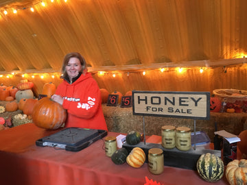 Barn counter filled with harvested pumpkins, squash, and farm honey